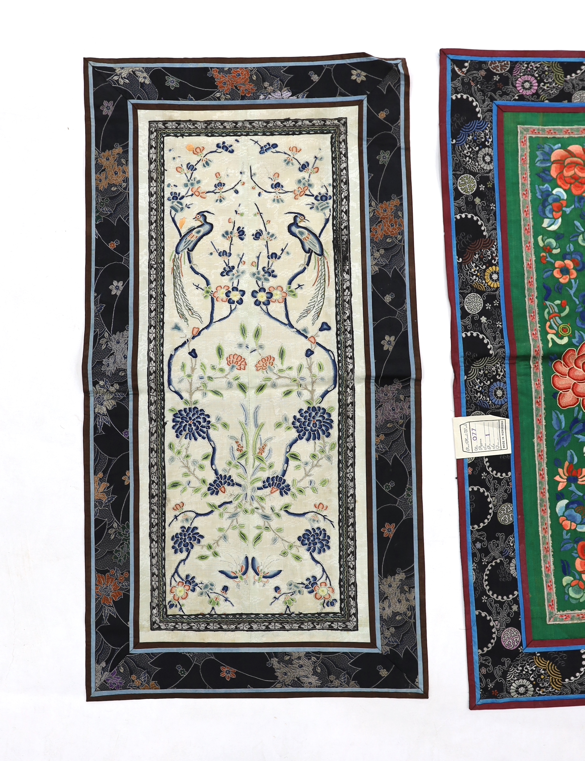 Three Beijing knot pairs of sleeve bands bordered with silk brocade and one pair embroidered with polychrome silks and gold thread longest, 73cm x 32cm including damask border